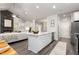 Open kitchen featuring a large island with sink and seating, and stainless appliances at 1053 Beechcraft Dr # 124, Mebane, NC 27302