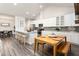 Bright kitchen with white cabinets, stainless steel appliances and a wood dining table at 1053 Beechcraft Dr # 124, Mebane, NC 27302