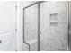 The walk-in shower showcases marble-tiled walls and glass doors for a modern and luxurious bathing experience at 1053 Beechcraft Dr # 124, Mebane, NC 27302