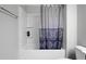 Clean white bathtub and shower equipped with a neutral patterned curtain, blending style and functionality at 109 Belle Plain Dr, Morrisville, NC 27560