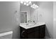 Bathroom with dark cabinets, double sinks, vanity lights and decorative towel holders at 109 Belle Plain Dr, Morrisville, NC 27560
