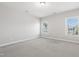 Bright carpeted bedroom with two windows allowing natural light to fill the room at 109 Belle Plain Dr, Morrisville, NC 27560