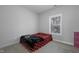 Small bedroom with neutral walls and carpet, a bed with colorful bedding, and natural light from a window at 109 Belle Plain Dr, Morrisville, NC 27560