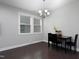 Inviting dining area with contemporary lighting, dark wood floors, and a modern table setting at 109 Belle Plain Dr, Morrisville, NC 27560