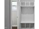 Hallway featuring a built-in mudroom bench with hooks and storage cubbies. Natural light from a window is present at 109 Belle Plain Dr, Morrisville, NC 27560