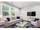 Comfortable living room with cream colored sofa, chair, and a stylish navy blue rug at 109 Belle Plain Dr, Morrisville, NC 27560