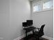 A home office featuring a modern desk, ergonomic chair, dual monitors, and natural light at 109 Belle Plain Dr, Morrisville, NC 27560