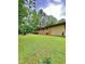 Large backyard with brick patio, partial privacy fence and mature trees at 1115 Park Ave, Henderson, NC 27536