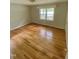 Bedroom with hardwood floors and natural light from the windows at 1115 Park Ave, Henderson, NC 27536