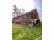 View of the home's exterior features a covered patio, perfect for outdoor entertaining and relaxation at 1115 Park Ave, Henderson, NC 27536