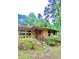 Close up of a well-maintained brick home with stone walkway and mature landscaping at 1115 Park Ave, Henderson, NC 27536