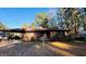 Brick home featuring a covered carport, front shrubs, and a welcoming facade at 1115 Park Ave, Henderson, NC 27536