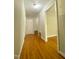 Hallway with wood floors leads to rooms, offering a glimpse into the home's layout at 1115 Park Ave, Henderson, NC 27536