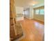Open concept living room with brick fireplace and hardwood floors at 1115 Park Ave, Henderson, NC 27536