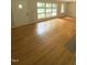 Bright living room with hardwood floors and large multi-pane windows at 1115 Park Ave, Henderson, NC 27536