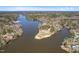 Serene aerial view of a lake community surrounded by lush green trees under a bright blue sky at 139 Oswego Dr, Louisburg, NC 27549