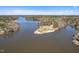 Expansive aerial view showcasing a lake surrounded by lush trees under a beautiful blue sky at 139 Oswego Dr, Louisburg, NC 27549