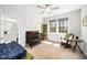 Light-filled Bedroom with a dark wood crib, rocker, and views of the wooded yard at 139 Oswego Dr, Louisburg, NC 27549