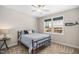 Cozy bedroom with a metal frame bed, blue bedding, and a window view of the construction site at 139 Oswego Dr, Louisburg, NC 27549
