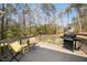 Relaxing outdoor deck space with patio furniture and a grill overlooking the backyard at 139 Oswego Dr, Louisburg, NC 27549