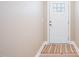 Cozy entryway with a white front door, neutral walls, and a striped rug at 139 Oswego Dr, Louisburg, NC 27549