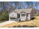 Inviting gray home featuring a front-facing garage and tasteful landscaping at 139 Oswego Dr, Louisburg, NC 27549