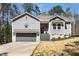 Charming exterior of a gray home with a gray garage door and beautiful front yard at 139 Oswego Dr, Louisburg, NC 27549