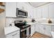 Modern kitchen with white cabinets, stainless appliances, and stylish backsplash at 139 Oswego Dr, Louisburg, NC 27549