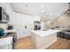 Modern kitchen with white cabinets, stainless steel appliances, and center island for ample prep space at 139 Oswego Dr, Louisburg, NC 27549