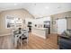 Bright kitchen with white cabinets, stainless appliances, and adjoining dining area with large window at 139 Oswego Dr, Louisburg, NC 27549