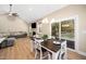 Open-concept living and dining area with a fireplace, television, and access to the outdoor deck at 139 Oswego Dr, Louisburg, NC 27549