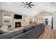 Open concept living room featuring vaulted ceiling, fireplace, and seamless flow to kitchen and dining areas at 139 Oswego Dr, Louisburg, NC 27549