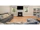 Comfortable living room with fireplace, TV, and ample natural light through well-placed windows at 139 Oswego Dr, Louisburg, NC 27549