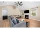 Inviting living room with vaulted ceiling, modern fireplace, and a comfortable seating arrangement at 139 Oswego Dr, Louisburg, NC 27549