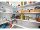 Organized pantry with shelving filled with storage bins, food, and wicker baskets at 139 Oswego Dr, Louisburg, NC 27549