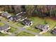 Aerial view showcases homes with large backyards and mature trees at 147 Everwood Dr, Four Oaks, NC 27524