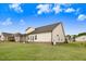 Rear view of home showing screened porch, well-maintained lawn, and vinyl siding at 147 Everwood Dr, Four Oaks, NC 27524