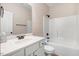 Bathroom with a vanity area, toilet, and a bathtub with a shower and tiled walls at 147 Everwood Dr, Four Oaks, NC 27524