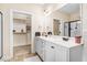 Elegant bathroom featuring double sinks, a large mirror, and a separate room for the shower and toilet at 147 Everwood Dr, Four Oaks, NC 27524