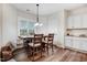 The dining room boasts natural light, hardwood flooring, and a seamless transition into the kitchen at 147 Everwood Dr, Four Oaks, NC 27524