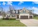 Charming two-story home with well-manicured lawn and a three-car garage at 147 Everwood Dr, Four Oaks, NC 27524