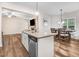 The kitchen features granite countertops, stainless steel appliances, and hardwood flooring, seamlessly connecting to a dining area at 147 Everwood Dr, Four Oaks, NC 27524