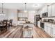 Beautiful kitchen features white cabinets, an island, stainless steel appliances, and hardwood flooring at 147 Everwood Dr, Four Oaks, NC 27524