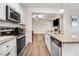 Well-equipped kitchen featuring modern stainless steel appliances, granite countertops, and ample cabinet space at 147 Everwood Dr, Four Oaks, NC 27524