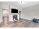 Bright living room with fireplace, hardwood floors, and neutral color palette at 147 Everwood Dr, Four Oaks, NC 27524