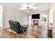 Comfortable living room with a fireplace and hardwood floors at 147 Everwood Dr, Four Oaks, NC 27524