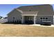 View of the backyard featuring a covered patio with a grill and hot tub at 149 Steep Rock Dr, Willow Springs, NC 27592