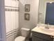 Neat bathroom with a shower-tub, toilet, and a vanity with a sink and gray cabinets at 149 Steep Rock Dr, Willow Springs, NC 27592