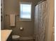 Bathroom with a toilet and a tub/shower with decorative curtain at 149 Steep Rock Dr, Willow Springs, NC 27592