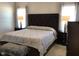 Primary bedroom featuring a tufted headboard, side tables with lamps, and neutral decor at 149 Steep Rock Dr, Willow Springs, NC 27592